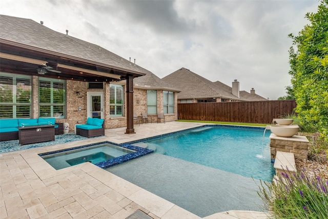 view of pool featuring a patio, a pool with connected hot tub, a ceiling fan, fence, and an outdoor living space