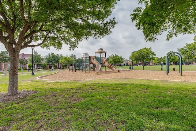 community jungle gym featuring a yard