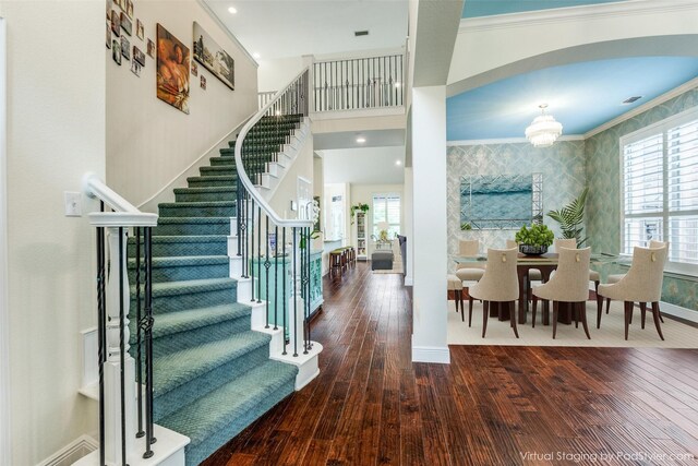 dining area with plenty of natural light, crown molding, a chandelier, and hardwood / wood-style flooring