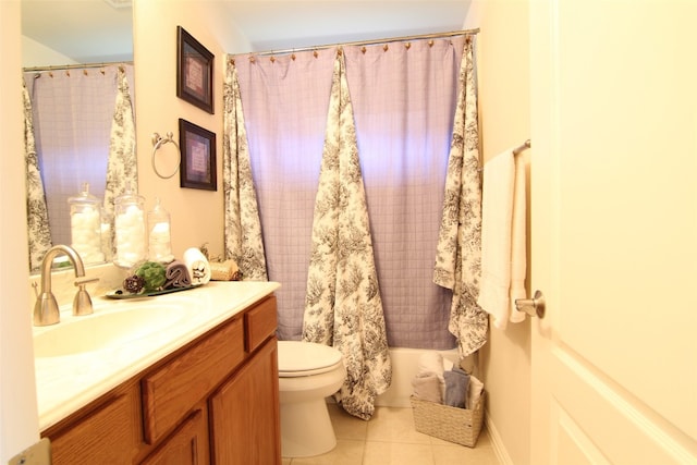 bathroom with tile floors, vanity with extensive cabinet space, and toilet