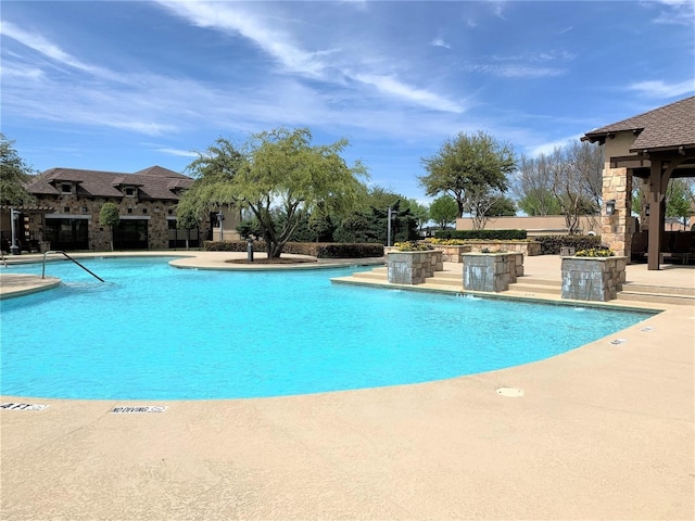 view of swimming pool featuring a patio and pool water feature