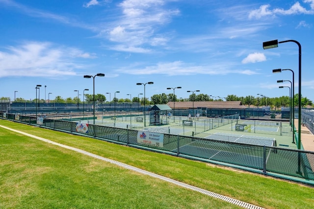 view of sport court featuring a lawn