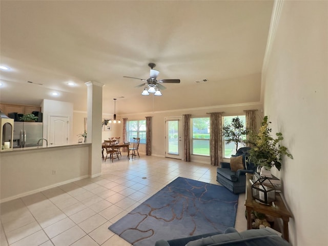 tiled living room with ornate columns, ceiling fan, and ornamental molding