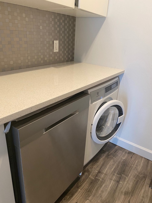 clothes washing area featuring washer / dryer and dark wood-type flooring