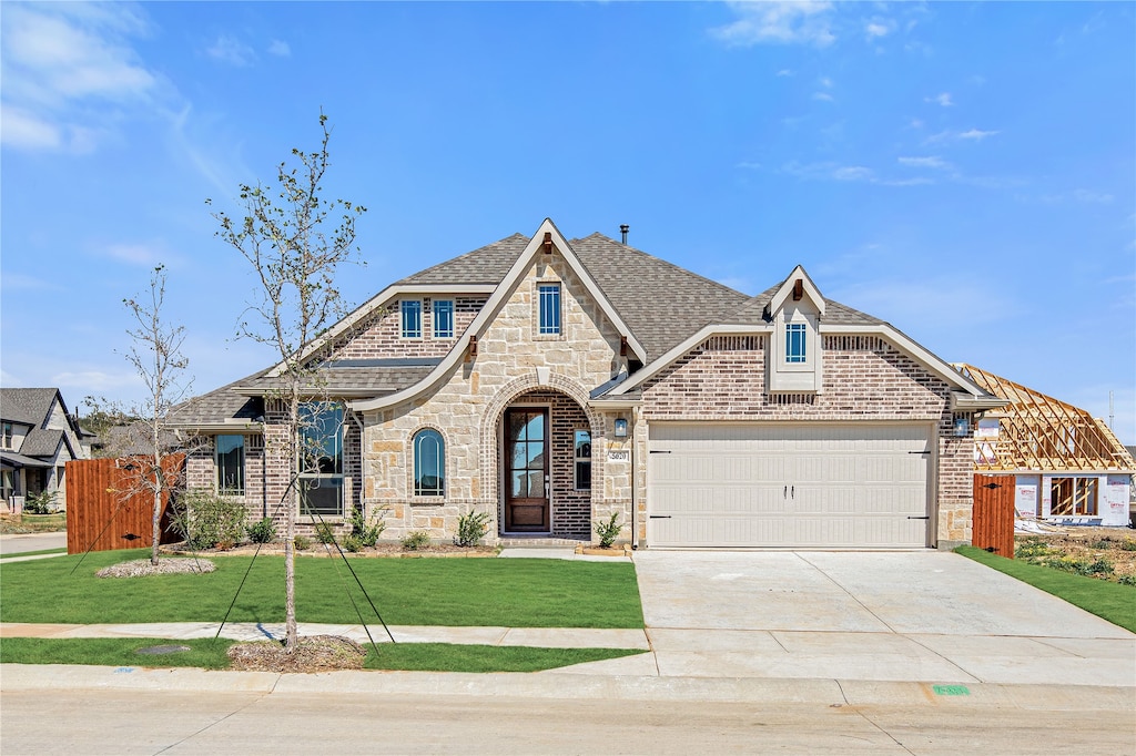 view of front of house with a front yard and a garage