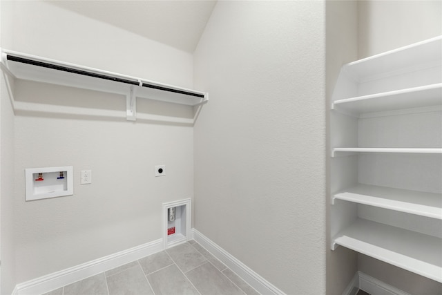 clothes washing area featuring light tile patterned floors, washer hookup, and hookup for an electric dryer