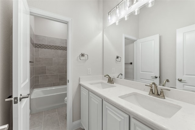 full bathroom with vanity, tiled shower / bath combo, toilet, and tile patterned flooring