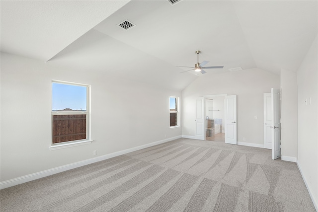 unfurnished room with light carpet, lofted ceiling, and ceiling fan