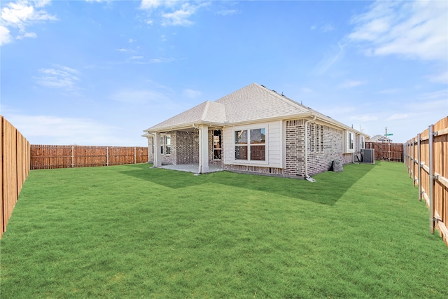 rear view of property with a patio and a yard