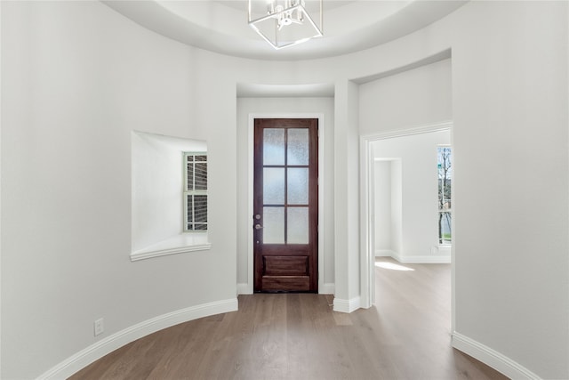 entrance foyer featuring a chandelier, light hardwood / wood-style floors, and plenty of natural light