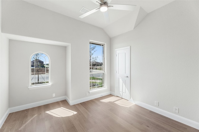 unfurnished room with ceiling fan, lofted ceiling, and light wood-type flooring