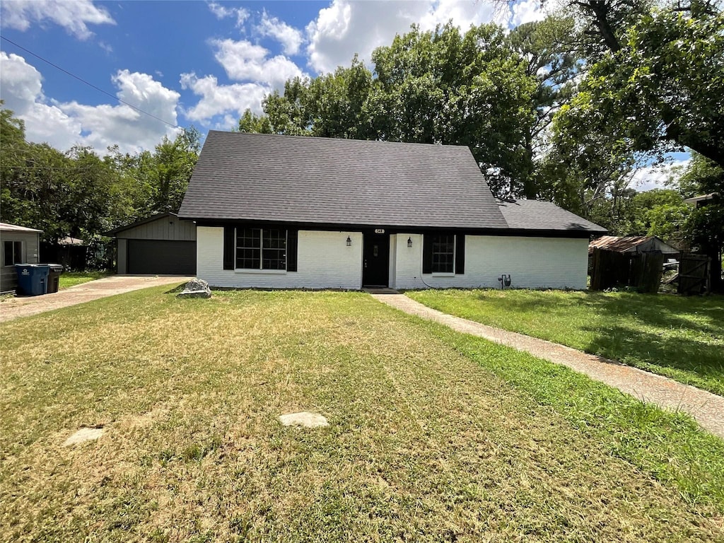 view of front of house with a garage and a front lawn