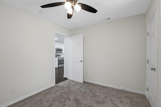 unfurnished bedroom with ceiling fan and dark wood-type flooring