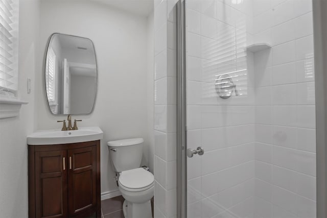 bathroom with a shower with door, tile flooring, toilet, and large vanity