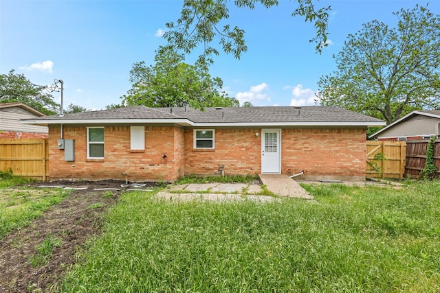 rear view of house with a yard