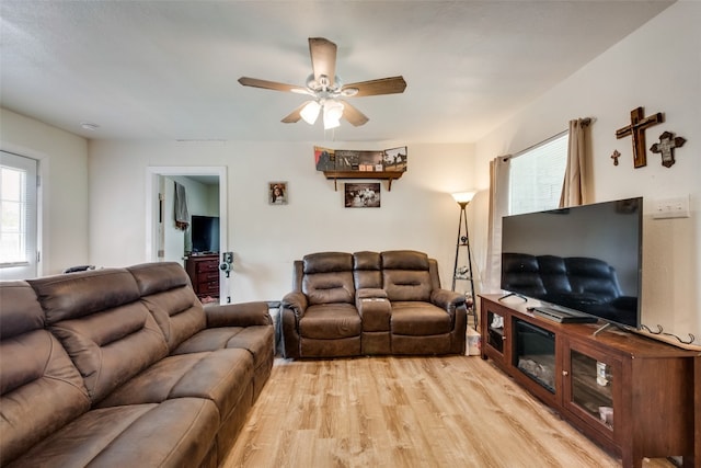 living room featuring light hardwood / wood-style floors and ceiling fan