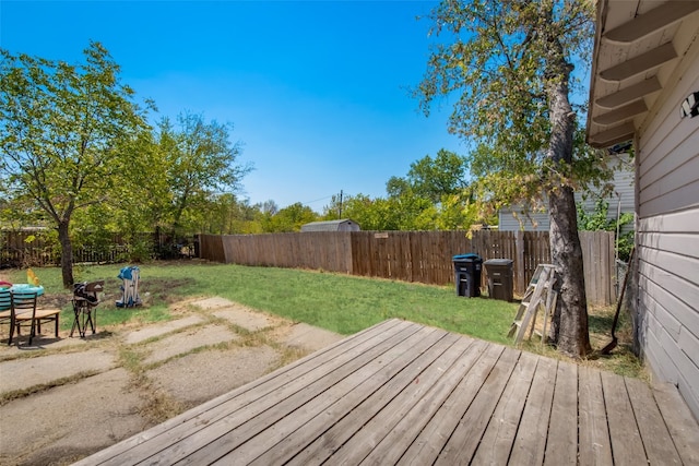 wooden deck featuring a lawn