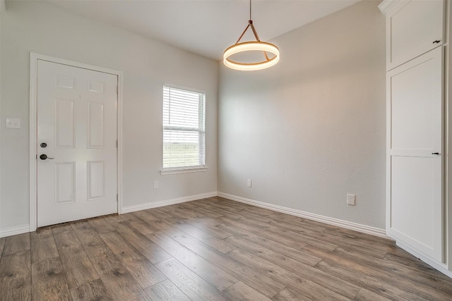 unfurnished room with hardwood / wood-style flooring