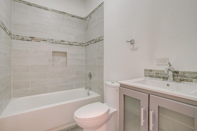 full bathroom with vanity, tiled shower / bath combo, and toilet