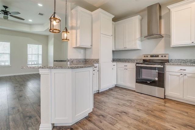 kitchen with light hardwood / wood-style flooring, wall chimney exhaust hood, and electric stove