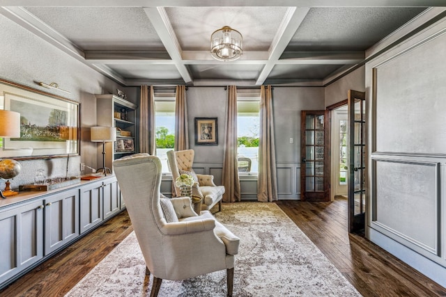 sitting room with beamed ceiling, a textured ceiling, dark hardwood / wood-style flooring, and coffered ceiling