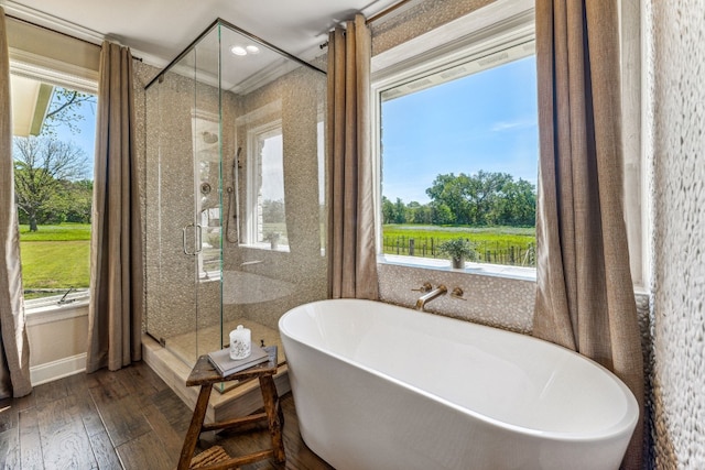 bathroom with ornamental molding, plenty of natural light, hardwood / wood-style floors, and plus walk in shower