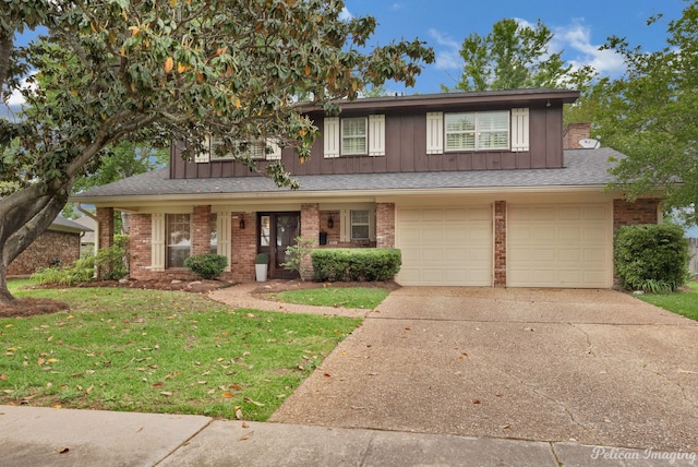 view of front of property with a garage and a front lawn