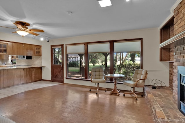 kitchen featuring light wood-type flooring, plenty of natural light, and a fireplace