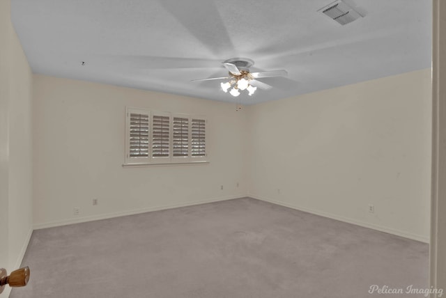 carpeted spare room with ceiling fan