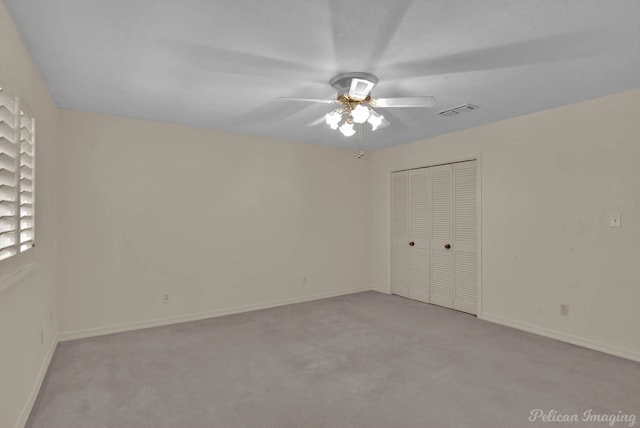 unfurnished bedroom with a closet, ceiling fan, and light colored carpet