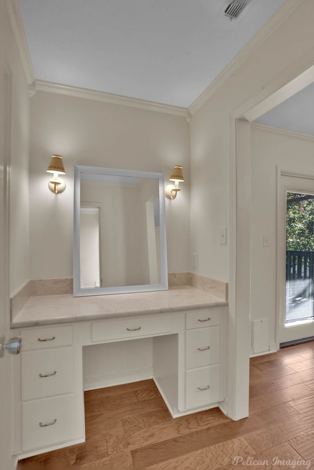 bathroom featuring ornamental molding, vanity, and hardwood / wood-style flooring