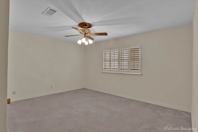 spare room featuring light carpet and ceiling fan