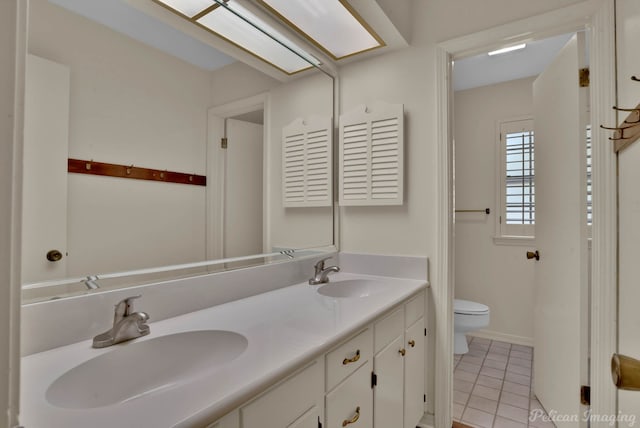 bathroom with vanity, toilet, and tile patterned floors