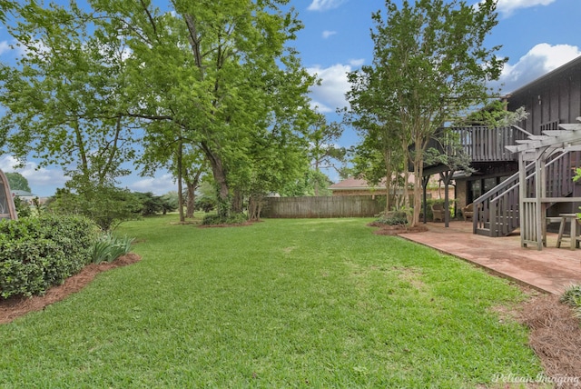 view of yard with a deck and a patio