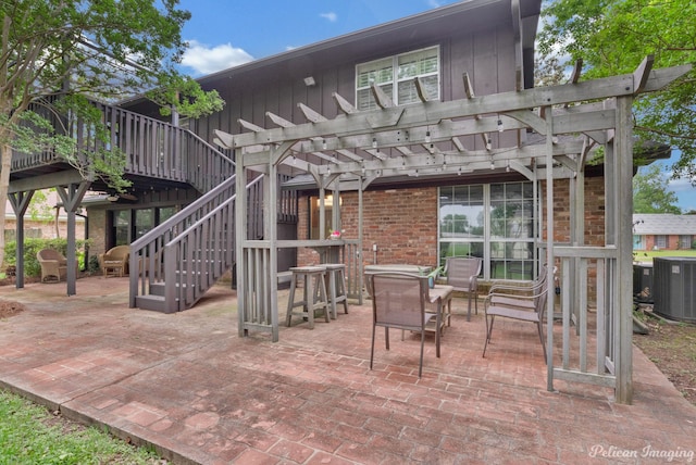 view of patio / terrace with central AC, a pergola, and a wooden deck