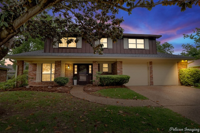 view of front of property featuring a garage and a yard