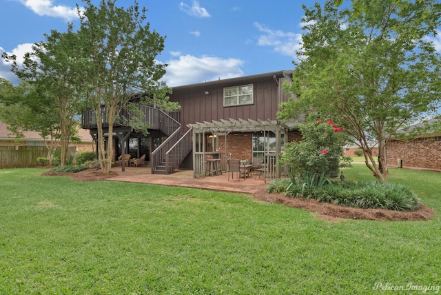 back of property with a pergola, a lawn, and a patio