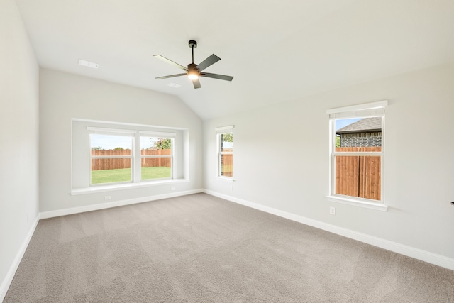 carpeted empty room with lofted ceiling and ceiling fan