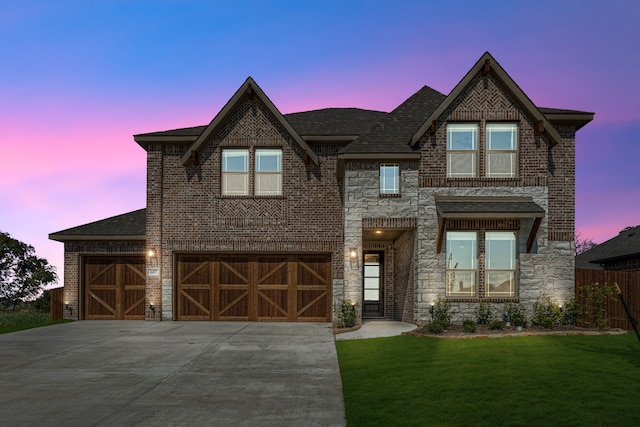 view of front of house with a yard and a garage