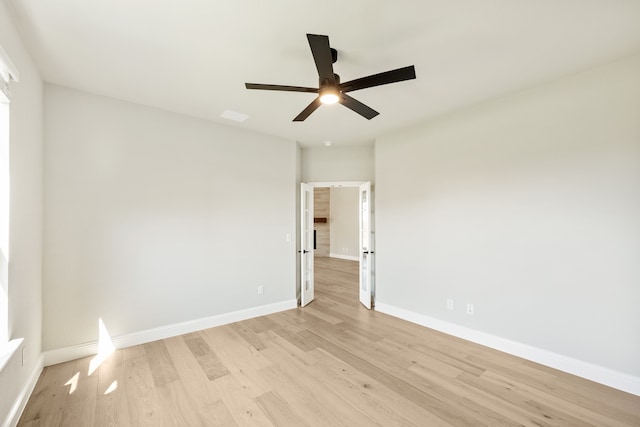 spare room with light hardwood / wood-style floors and ceiling fan