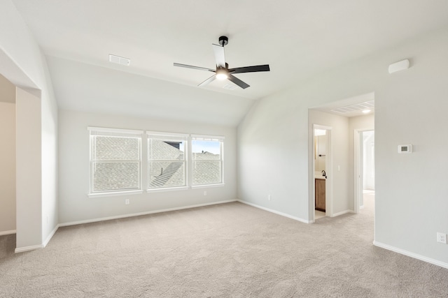 empty room with light carpet, vaulted ceiling, and ceiling fan