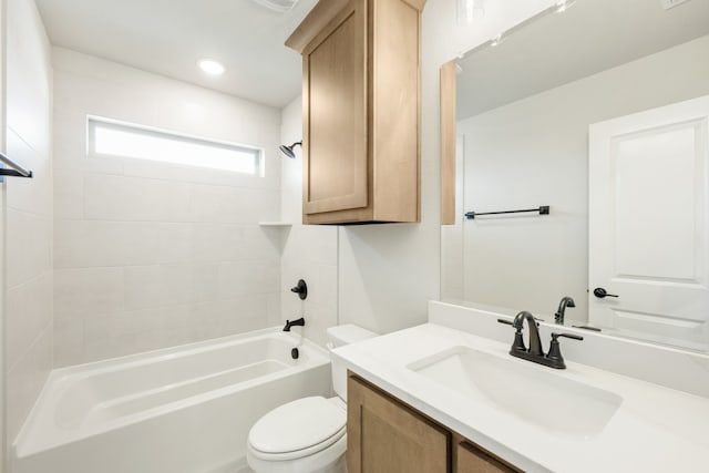 full bathroom with toilet, tiled shower / bath combo, and vanity