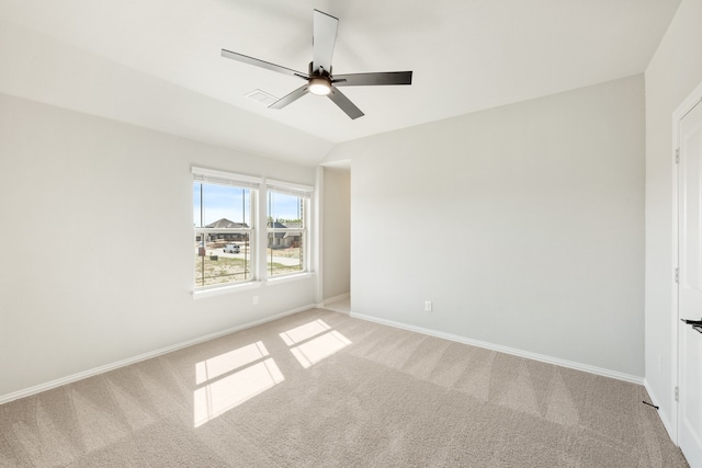 carpeted empty room with ceiling fan and lofted ceiling