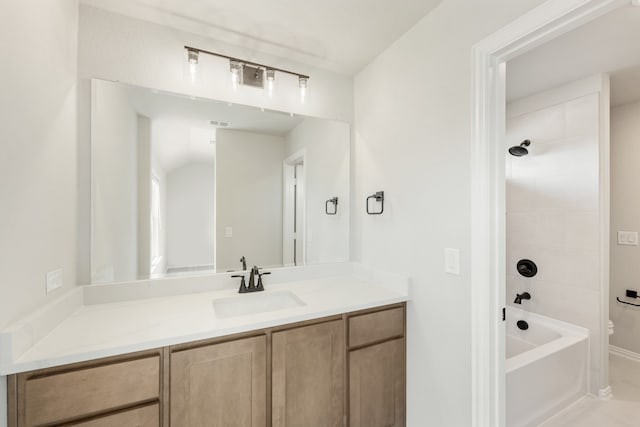 full bathroom featuring vanity, toilet, and tiled shower / bath combo