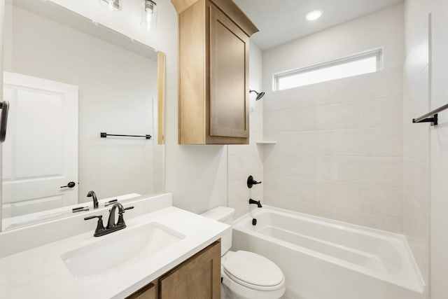 full bathroom with vanity, toilet, and tiled shower / bath