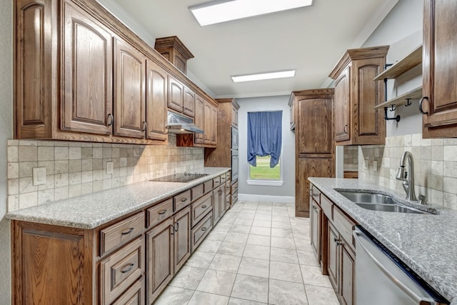 kitchen featuring stainless steel appliances, sink, backsplash, light tile patterned floors, and light stone countertops