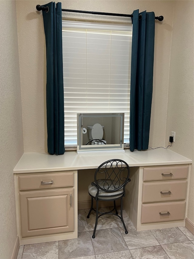 tiled office space featuring built in desk