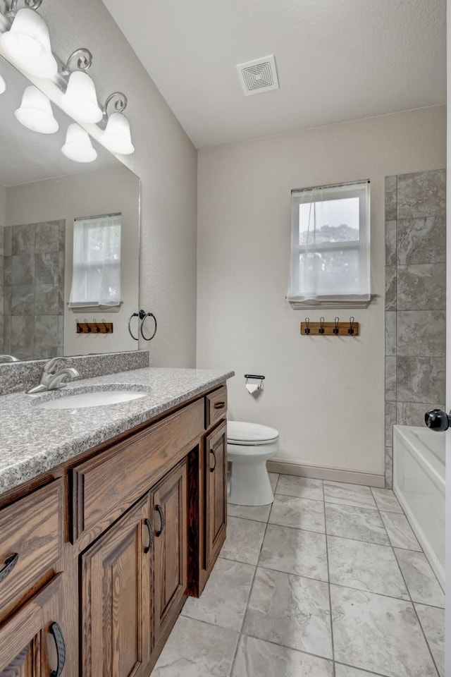 full bathroom featuring toilet, vanity, and  shower combination