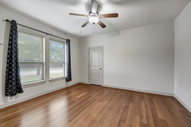 unfurnished room with ceiling fan and hardwood / wood-style floors