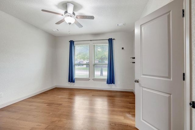 unfurnished room with ceiling fan and light hardwood / wood-style flooring